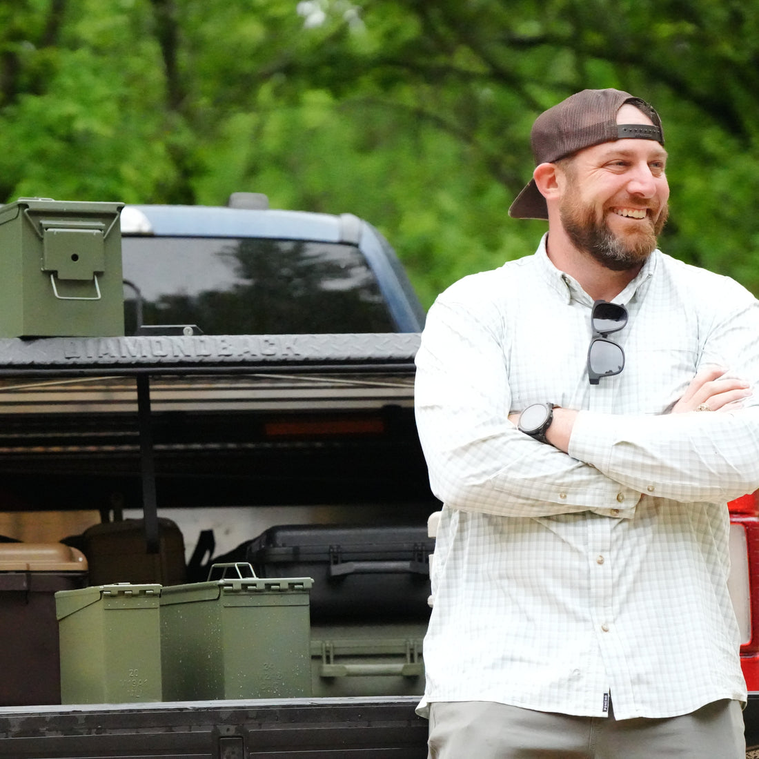 Man standing by a truck with clean ammo cans on the tailgate